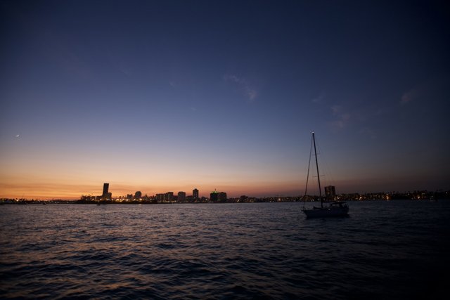 Sunset Sailboat on the City Skyline