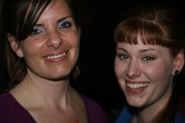 Two Young Women Smiling at a Nighttime Event