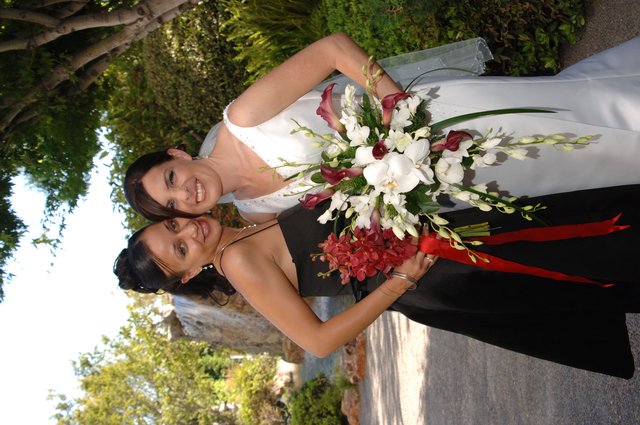 Bride and Bridesmaid Celebrate Together in Garden