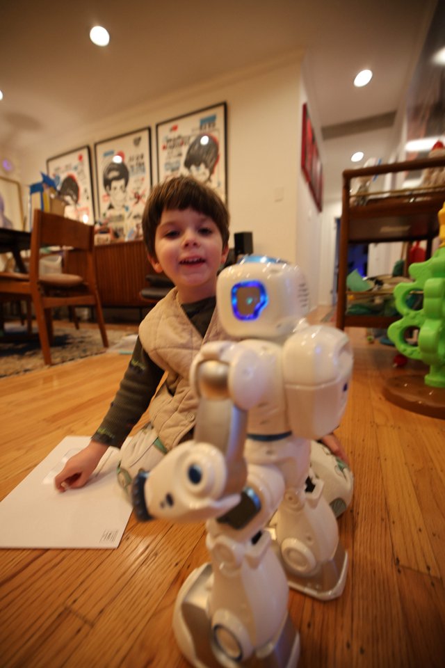 Child Playing with Robot Toy at Home