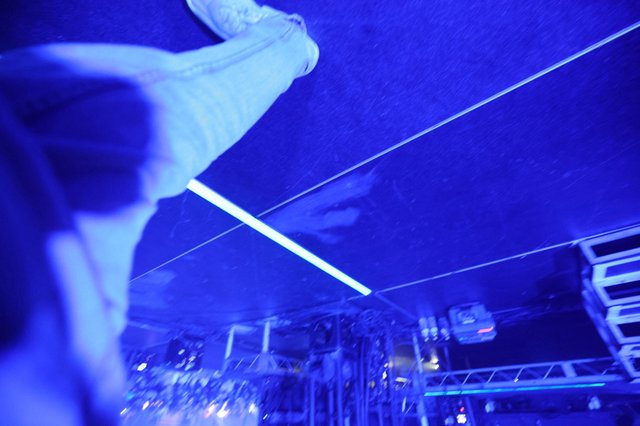 Crowd Surfer Soars Over Blue-Lit Festival Stage