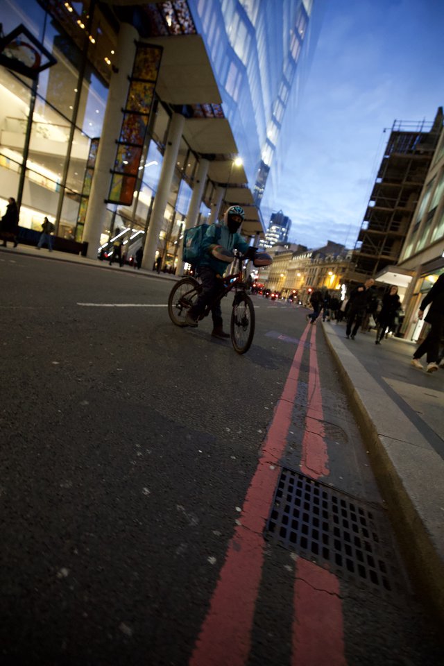 Evening Cyclist on London's Red Route at Twilight