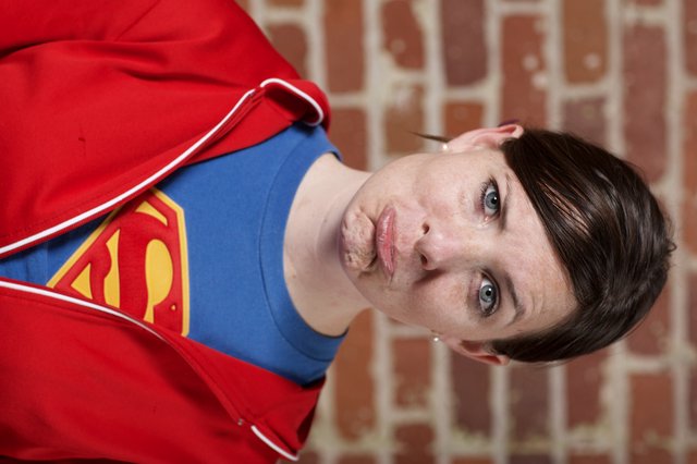 Supergirl Pouting Against Brick Wall Portrait