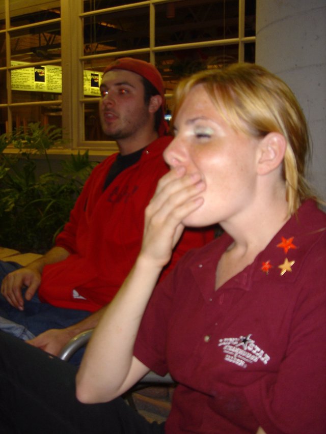 Two Friends Watching Intently at Indoor Event