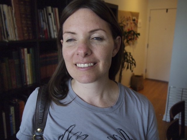 Smiling Woman with Dark Hair in Home Library
