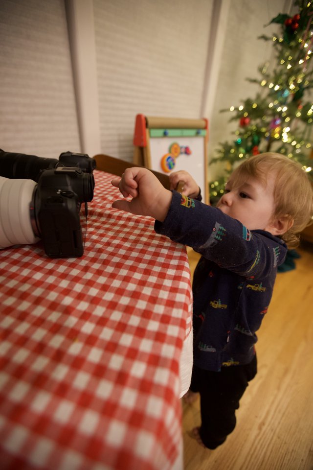 Curious Toddler Exploring Camera on Christmas Morning