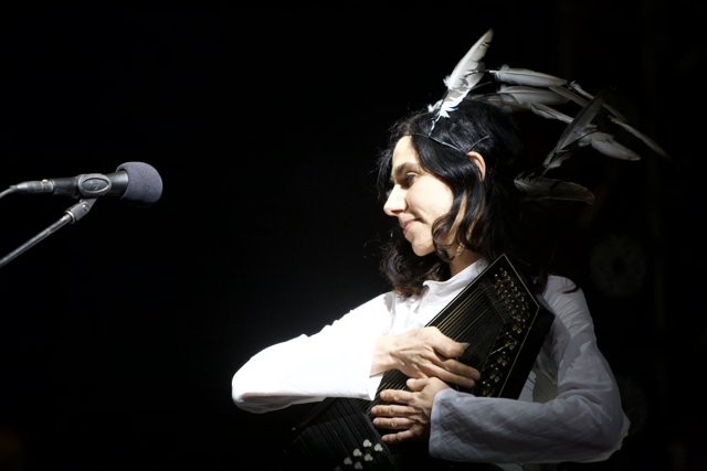 PJ Harvey Playing the Accordion with Feather Headpiece