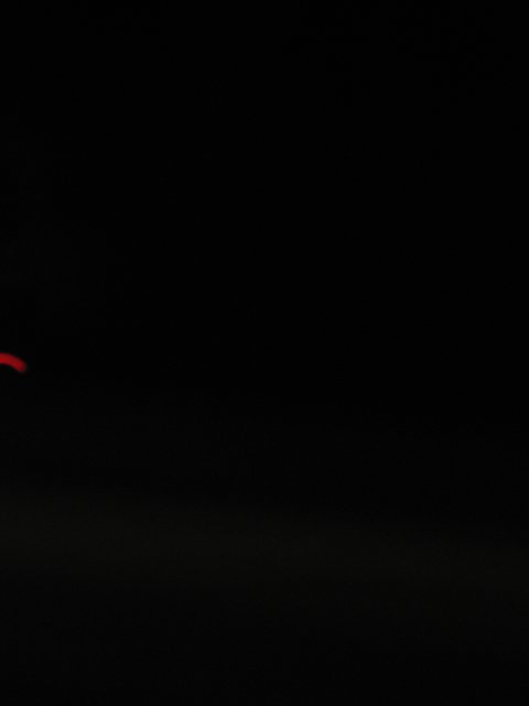 Red Car Racing Through the Night Sky