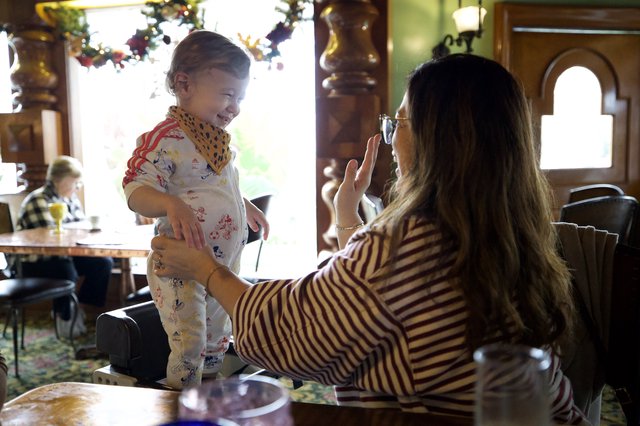 Mother Capturing Joyful Moment with Toddler at Home