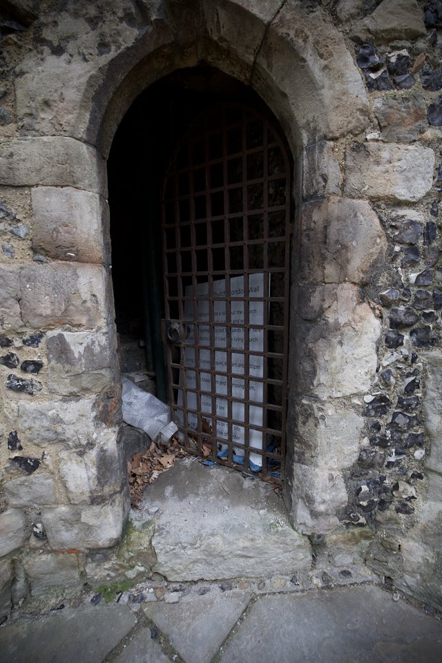 Ancient Stone Archway with Iron Portcullis Gate