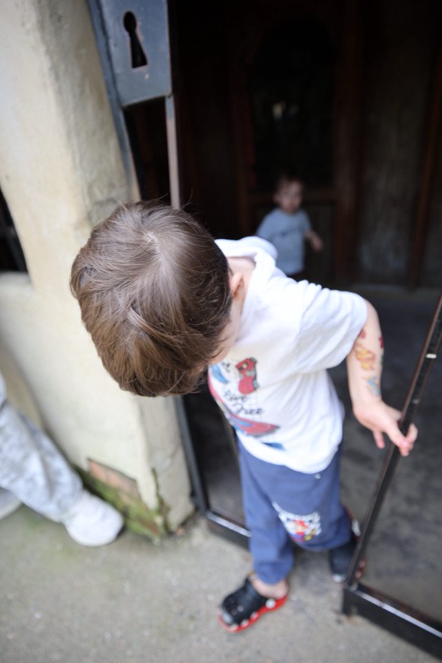 Young Boy Peering Through Mysterious Doorway at Fantasyland
