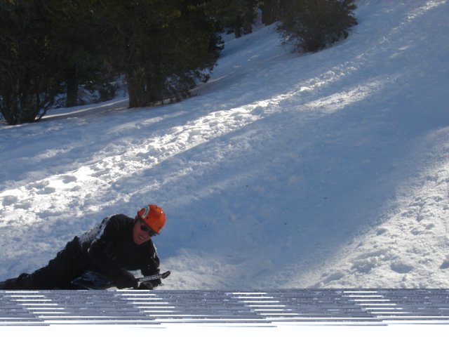 Snowboarder carving down the slope