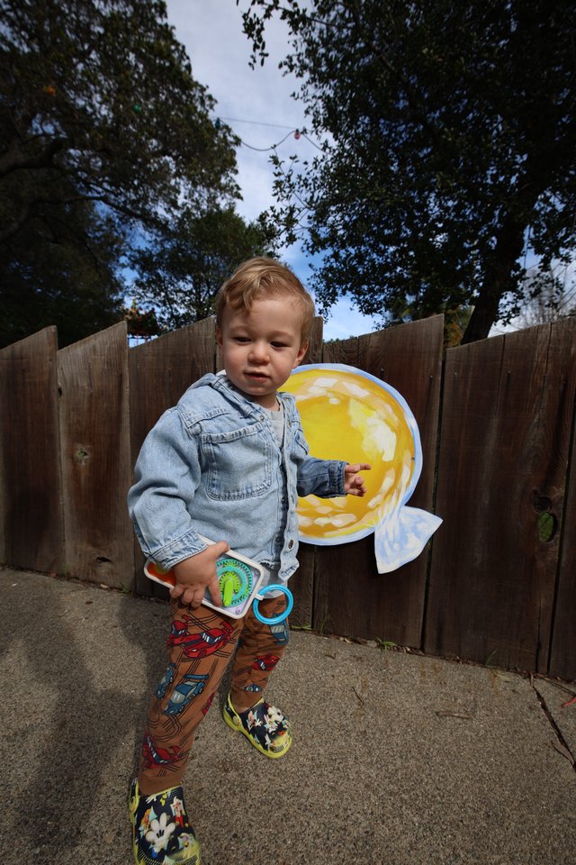 Toddler Playing with Toy Fishing Set in Backyard