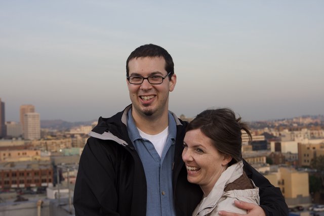 Couple Smiling Together Against City Skyline