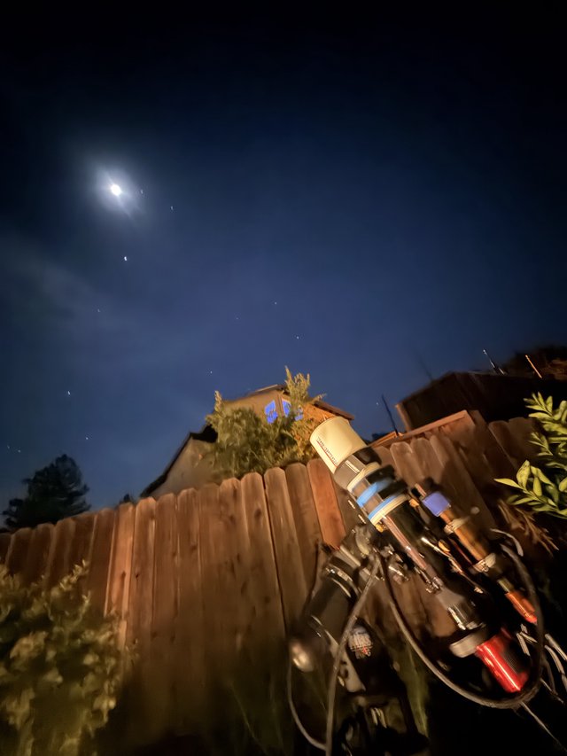 Backyard Telescope Under Moonlit Night Sky
