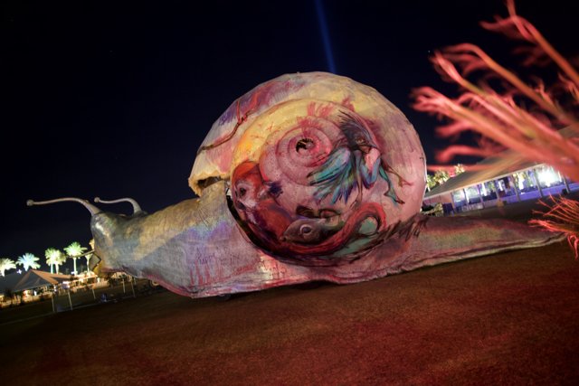 Glimmering Snail Sculpture in the Night Sky