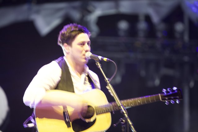 Man Entertains Coachella Crowd with Acoustic Guitar and Microphone