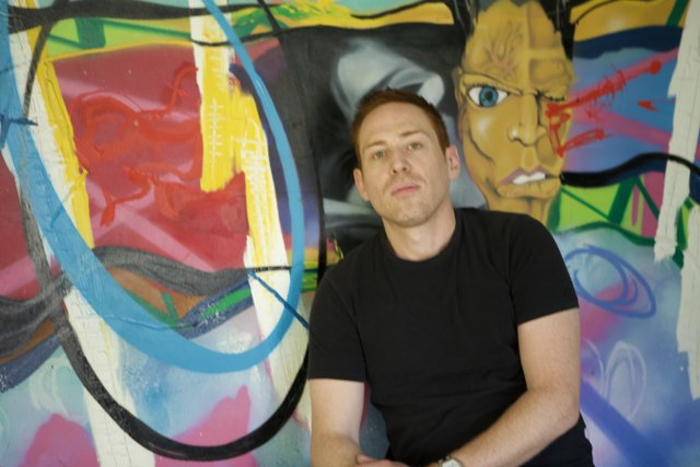 Portrait of a Man in Front of a Colorful Wall