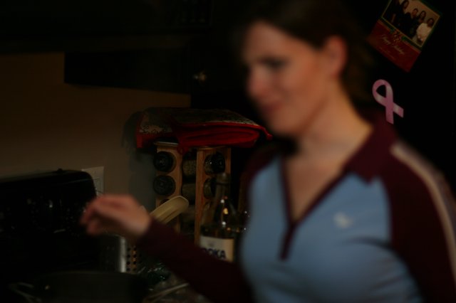 Woman Smiling in Dimly Lit Home Kitchen