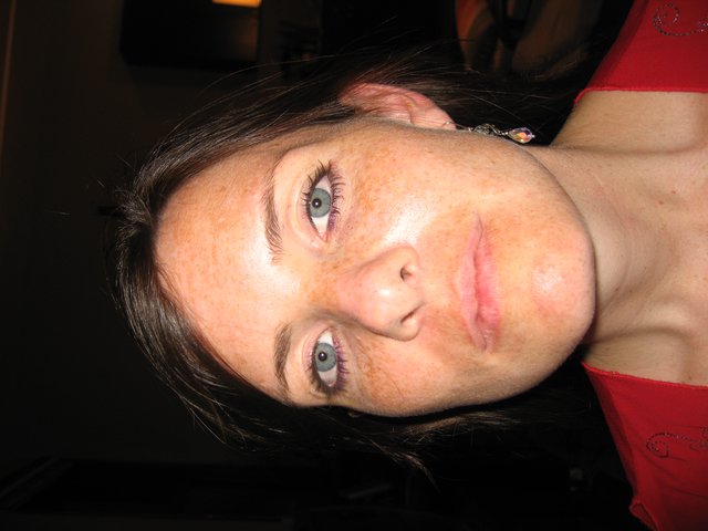 Freckled Woman in Red at Indoor Night Setting