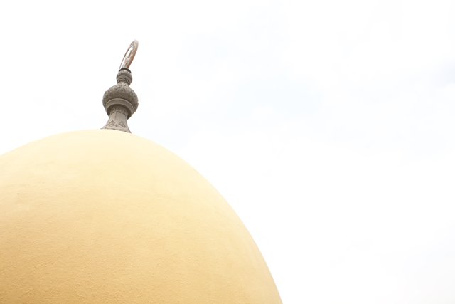 The Majestic Yellow Dome with a White Cross on Top