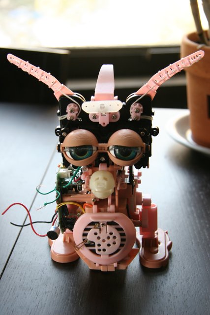 Pink-Eared Robot Plays with Its Cord