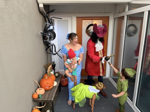 Family Halloween Trick-or-Treating at Front Door
