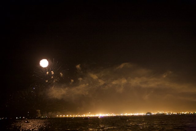 Fireworks Spectacle Over the Moonlit Bay