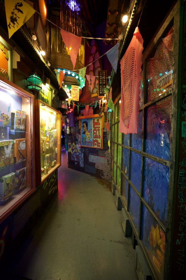 Colorful Narrow Alleyway with Festive Decorations and Art