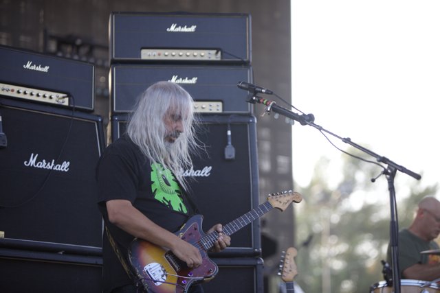 The White-Haired Guitarist: A Musical Performance on Stage