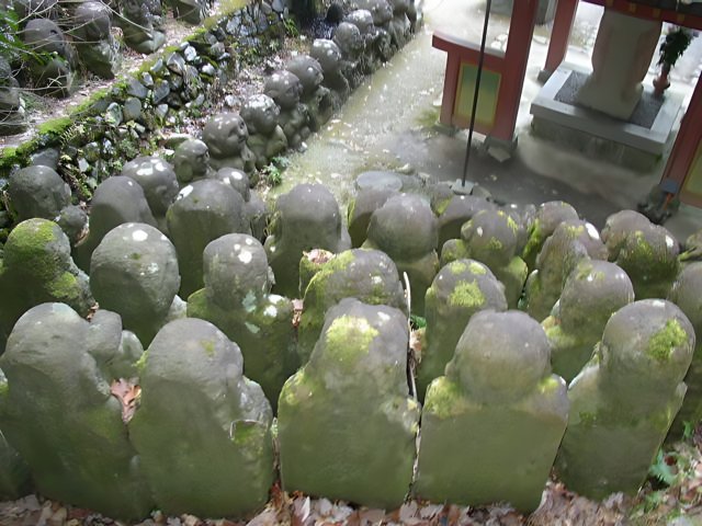 Mossy stone statues amongst the rocks
