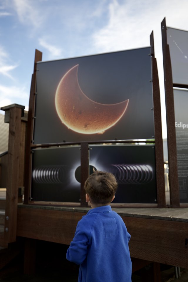 Child Observing Solar Eclipse Educational Display