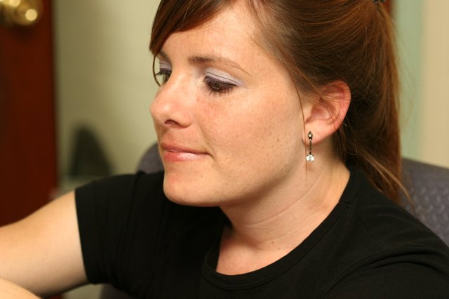 Thoughtful Woman in Profile with Statement Eye Makeup