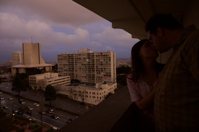 Romantic Kiss on Hotel Balcony at Twilight Dusk