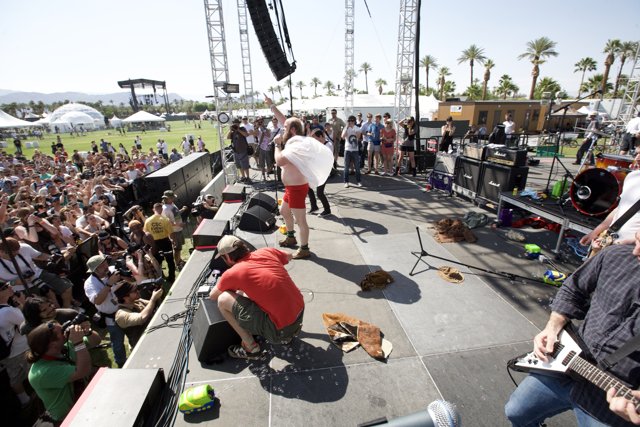 Man in Red Shorts Playing Guitar at Coachella Concert