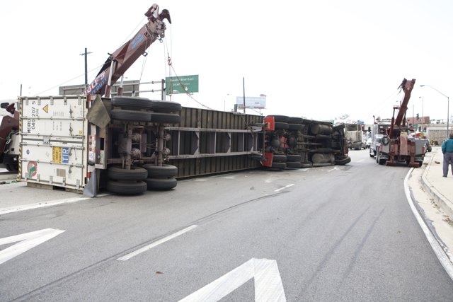 Overturned truck lifted by crane