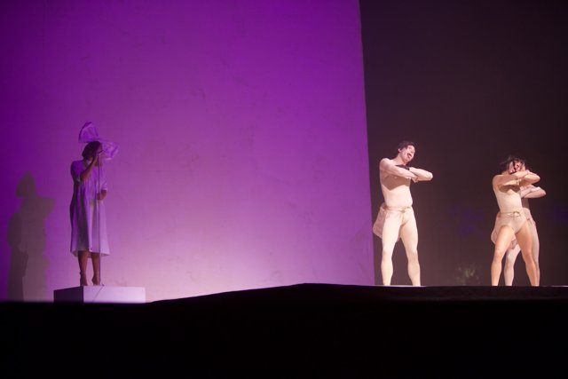 Three Dancers in White Body Suits Take Center Stage