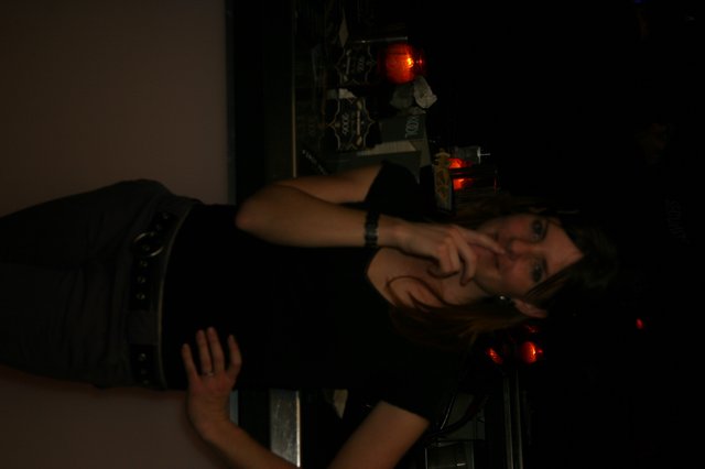 Woman Smoking at a Dimly Lit Bar Counter