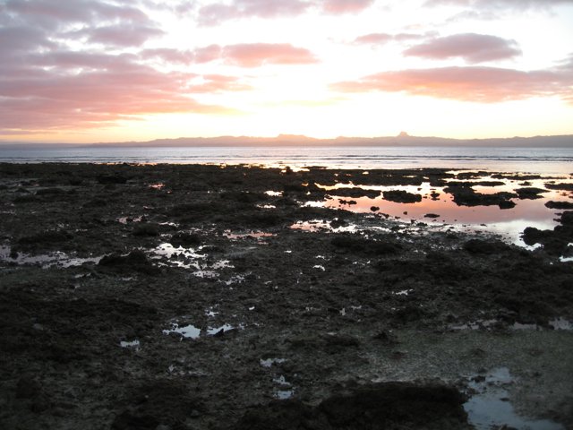 Serene Sunset View over Rocky Shoreline