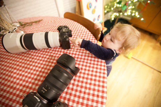 Young Child Napping with Photography Equipment at Christmas