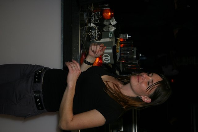 Woman Reading New Year's Eve Program at Nightclub Bar