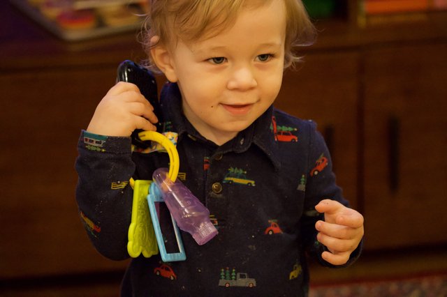 Toddler Playing with Toy Keys and Phone