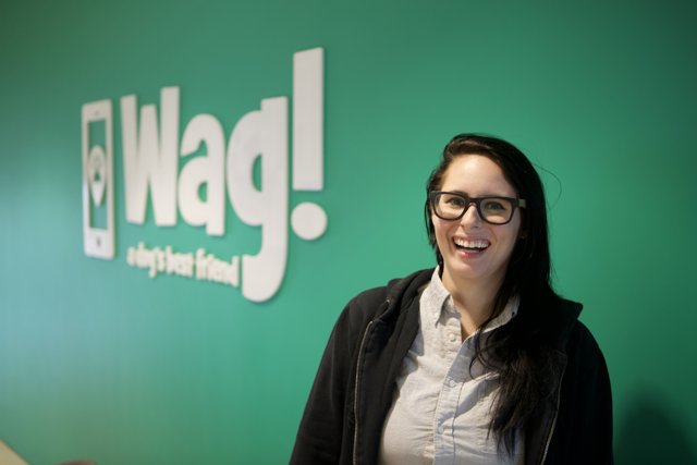 Happy Woman in Glasses with Wag Logo