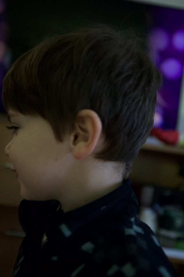 Young Boy in Contemplative Moment at Evening Event