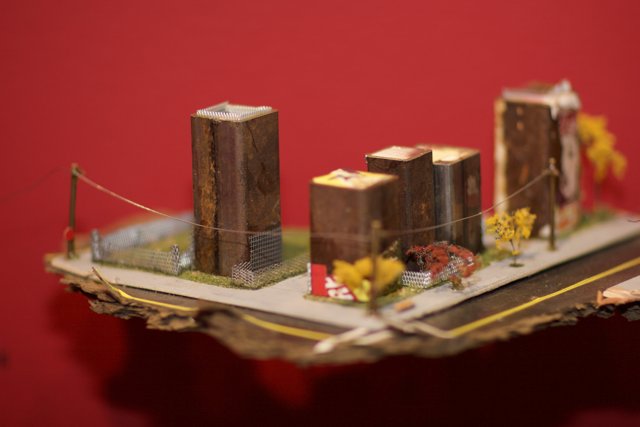 Miniature Cityscape on a Table, Adorned with Sweet Treats and Floral Imageries