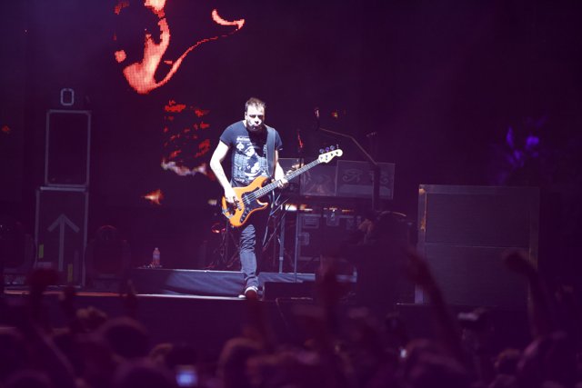 Christopher Wolstenholme Rocking the Stage with his Guitar