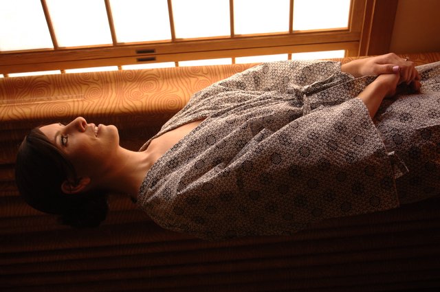 Bride in Robe Gazing Thoughtfully Through Morning Window