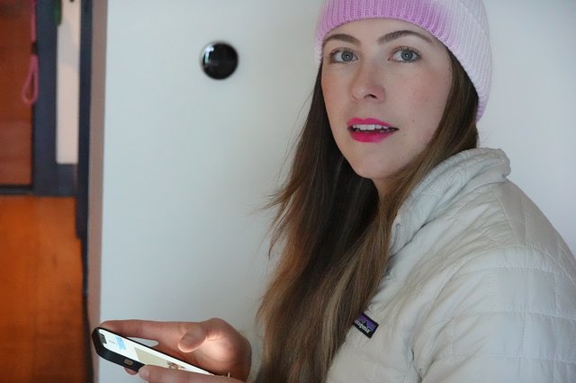 Woman with Pink Beanie Using Smartphone Indoors