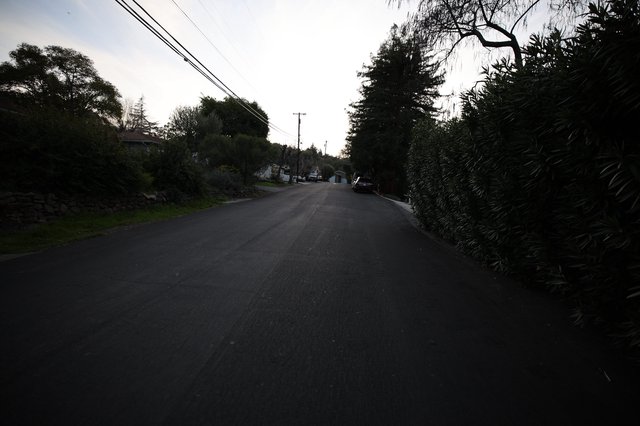 Quiet Residential Street at Dusk with Overhead Power Lines