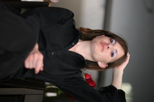 Contemplative Woman in Black at Office Setting
